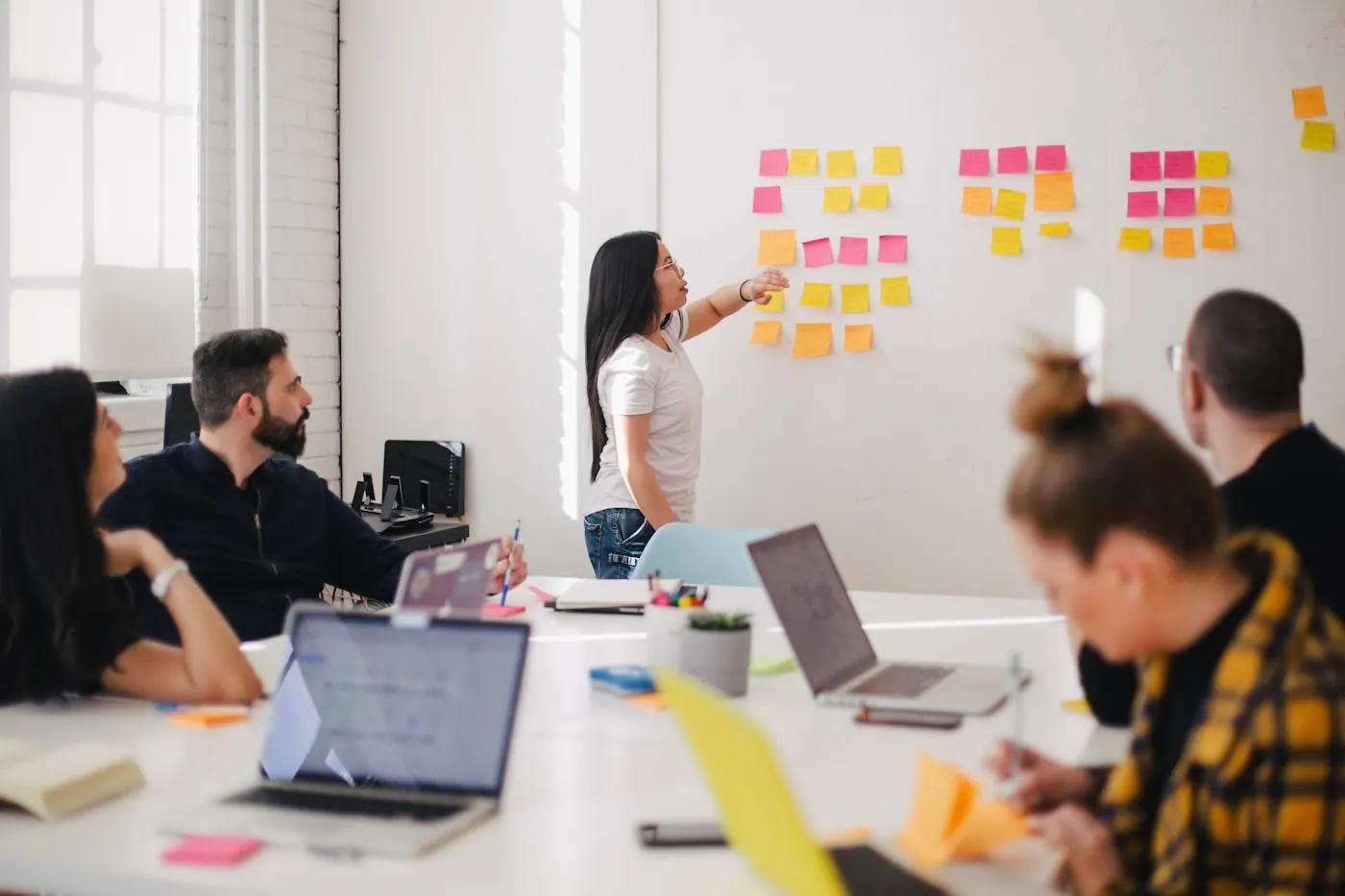 Business team planning and assessing risks with sticky notes