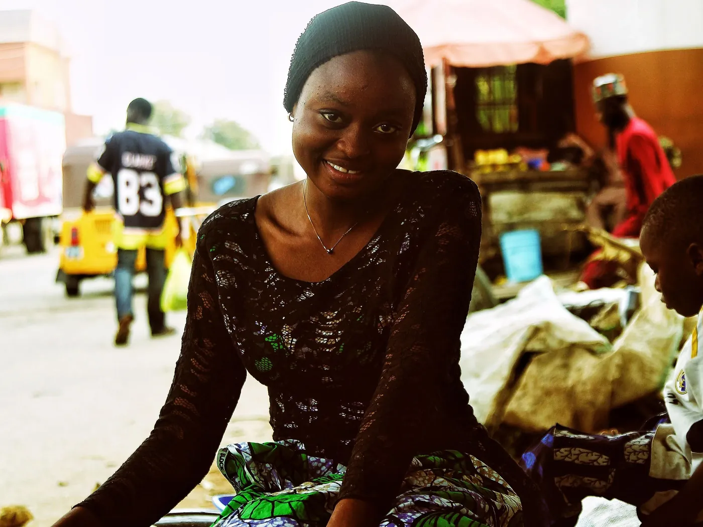 Smiling Nigerian market woman, small business owner in Abuja, Nigeria